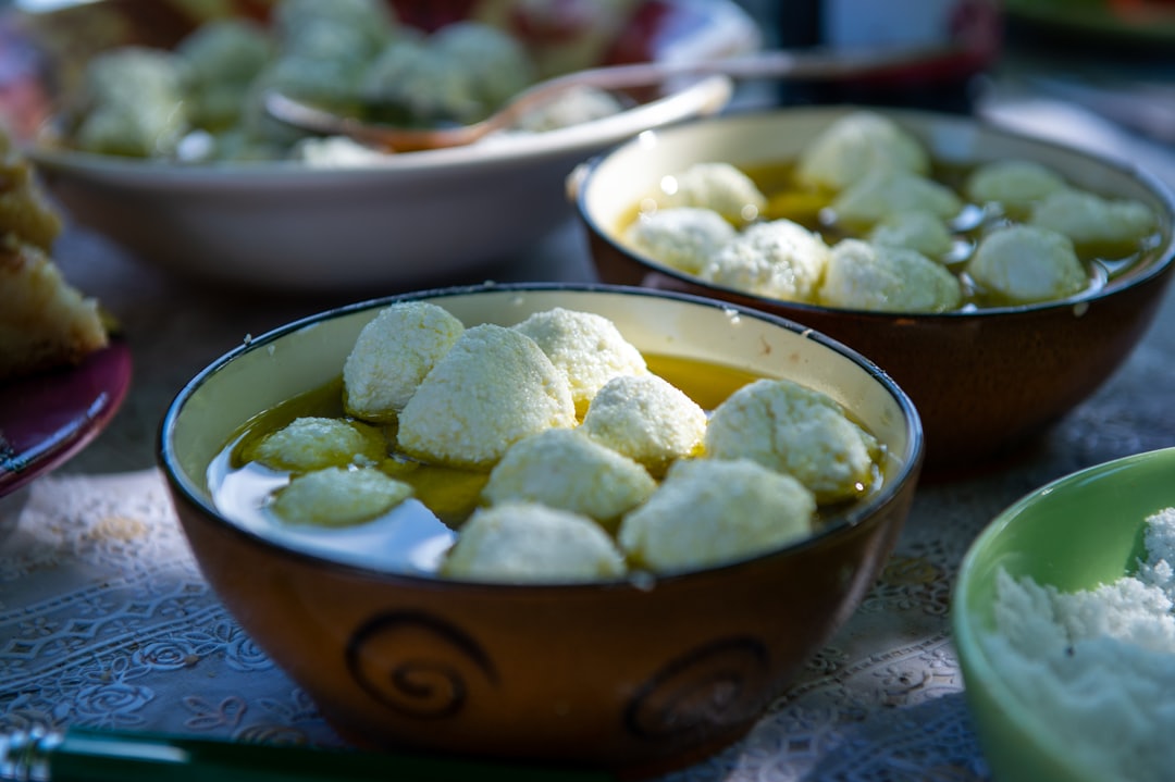 Budwig kuren symboliseret ved foto af 5-6 skåle med hytteost i kugler, der flyder ovenpå en suppe.