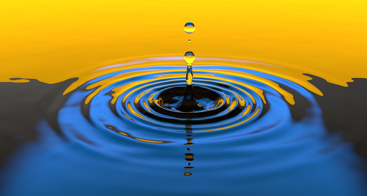 Deep oscillation behandling symboliseret ved et par vanddråber der rammer en vandoverflade og skaber de typiske ringe i omkredsen. Vandet er blåt i fronten og gyldent i øverste halvdel af billedet.