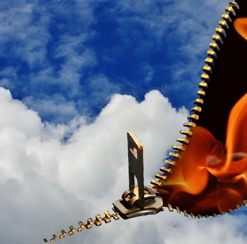 Min kræfthistorier symboliseret ved en lynlås ind over en himmel. Der er et kig til ild og sort baggrund bag dette.