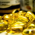 Vitamin-E symboliseret ved gyldne kapsler.