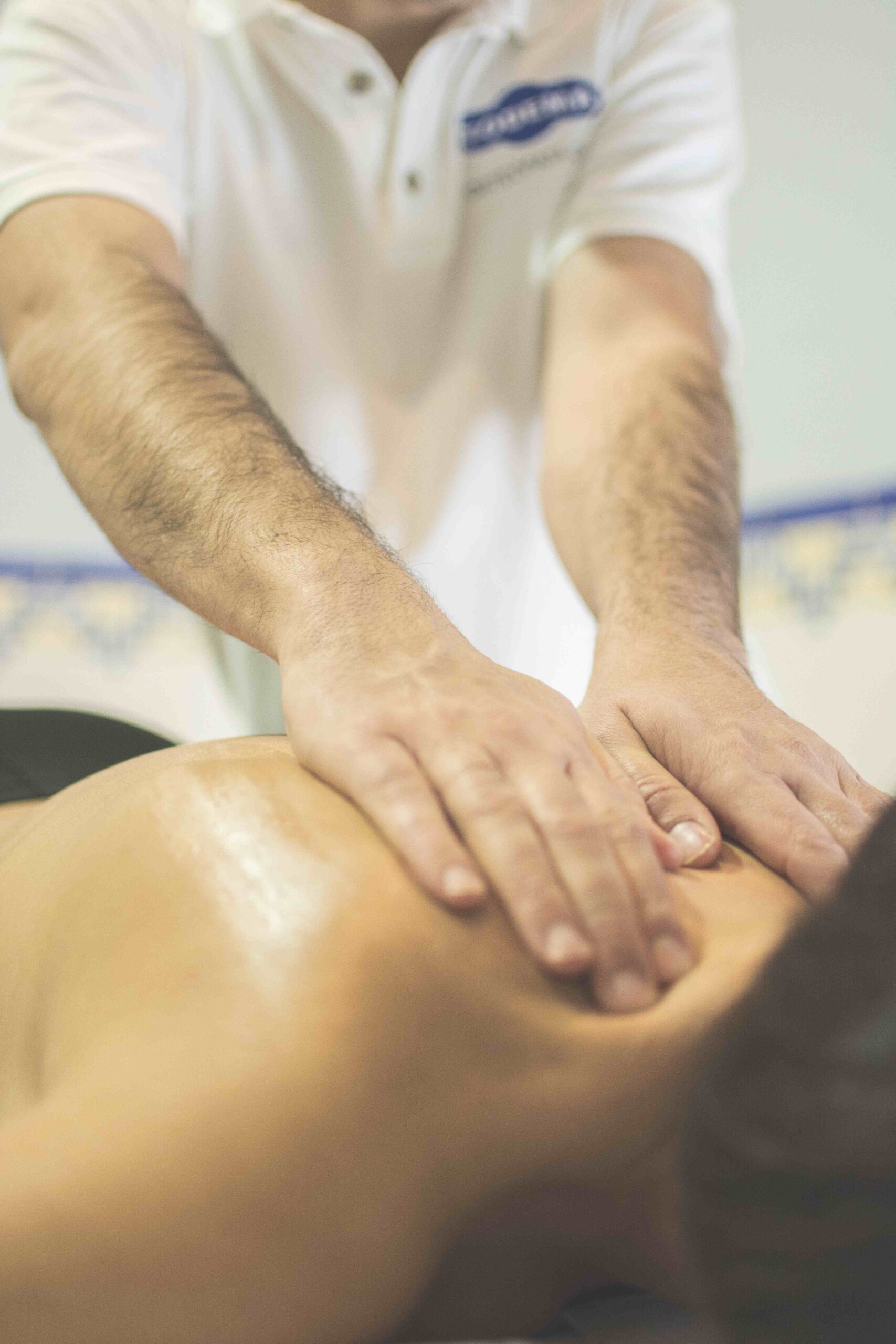 Fysioterapi symboliseret ved  en nøgen nakke og ryg, der modtager massage.